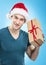 Handsome man in santa hat - hand gift box