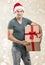 Handsome man in santa hat - hand gift box