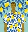 Handsome man in a shirt with lemons print on a lemon tree background.