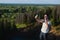 Handsome man shooting selfie in the nautre. Hiking trip. Mountaineering moments. Shooting beautiful views of forest