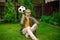 Handsome man sits on lawn spinning soccer ball on index finger, sports betting