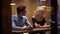 Handsome man sitting in restaurant and flirting with shy woman, relationship