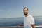 Handsome man smiling on the deck of a ship during holidays.