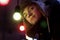 Handsome man standing under retro garland lights bulbs at street