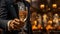 Handsome man in suit with champagne on sparkling bokeh gold background. Portrait of elegance gentleman with glasses
