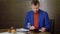 Handsome man on table in restaurant and using tablet pc while waiting order food