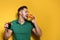 Handsome man with tasty burger and cola on color background