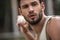 Handsome man throwing baseball ball on court