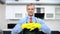 handsome man in tie and apron wearing rubber gloves