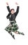 Handsome man in traditional Scottish costume jumping