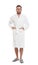 Handsome man wearing bathrobe on background