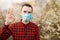 Handsome man wearing surgical hygienic protective cloth face mask and show OK sign