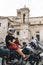 Handsome man in white helmet sitting on old adventure motorbike. Travel and vacation concept. Freedom. Vertical photo. Narni,