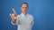 Handsome mature man, in cool casual fashion, seriously gesturing \\\'no\\\' with his finger, standing isolated against a stark white