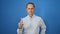 Handsome mature man, in cool casual fashion, seriously gesturing \\\'no\\\' with his finger, standing isolated against a stark white