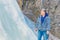 Handsome mature tourist by a frozen waterfall