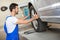 Handsome mechanic changing a tire