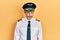 Handsome middle age man with grey hair wearing airplane pilot uniform skeptic and nervous, frowning upset because of problem