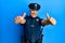 Handsome middle age mature man wearing police uniform approving doing positive gesture with hand, thumbs up smiling and happy for