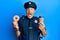 Handsome middle age mature police man eating donut and drinking coffee celebrating crazy and amazed for success with open eyes