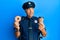 Handsome middle age mature police man eating donut and drinking coffee smiling looking to the side and staring away thinking