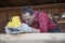 Handsome middle-aged carpenter works on wooden workpiece with milling tool