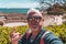 handsome middle aged man visiting tarraco archaeological complex, Tarragona - Happy tourist taking a selfie in front of roman