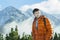 Handsome mountaineer posing at astonishing snowy rocky landscape background