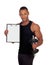 Handsome muscled man training with dumbbells and clipboard in bl