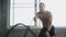 handsome Muscular bodybuilder man exercises with battle ropes at gym . Shirtless fitness young sport man training .work out