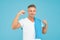 Handsome and muscular. Handsome man with towel on blue background. Athlete flex biceps triceps arm. Male adult with