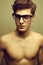 Handsome muscular male model with nice body wearing glasses