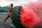 Handsome muscular man flipping big tire outdoor.