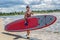 Handsome muscular man holding surfboard.