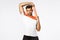 Handsome muscular sexy young sportsman in sports t-shirt, hold hands over head and stretching resistance band with