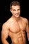 Handsome muscular young man isolated on black