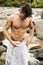 Handsome muscular young man outdoor wearing only towel