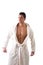 Handsome muscular young man wearing white bathrobe