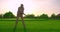 Handsome older golfer swinging golf club, golfing in paradise.