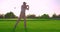 Handsome older golfer swinging golf club, golfing in paradise.