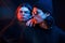 Handsome people. Portrait of twin brothers. Studio shot in dark studio with neon light