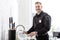 Handsome police officer washing dishes