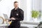 handsome policeman smiling and using laptop