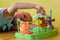 Handsome preschool boy plays toys in playroom