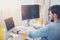 Handsome programmer using laptop in a cozy office