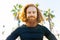 handsome redhaireb man with long beard wear black sporty suit and warming up in sunny beach