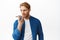 Handsome redhead man record voice message, holding smartphone near lips as translating his words in cellphone app, using