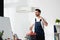 Handsome repairman standing with toolbox near