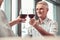 Handsome retired man drinking red wine in a restaurant