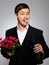 Handsome romantic young man with rose flower
